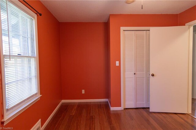 159 Evans Ln, Wilkesboro, NC 28697 - unfurnished bedroom featuring a closet, baseboards, and wood finished floors