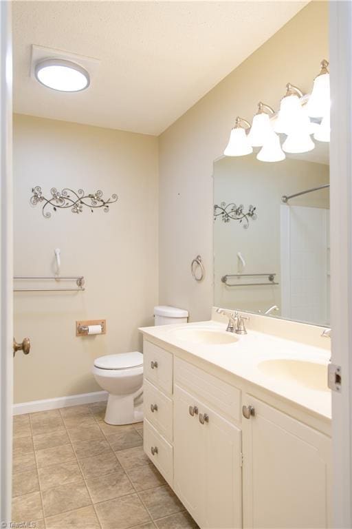 159 Evans Ln, Wilkesboro, NC 28697 - bathroom with double vanity, baseboards, a sink, and toilet