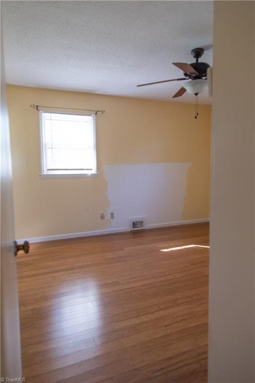159 Evans Ln, Wilkesboro, NC 28697 - spare room with wood finished floors, ceiling fan, baseboards, and visible vents
