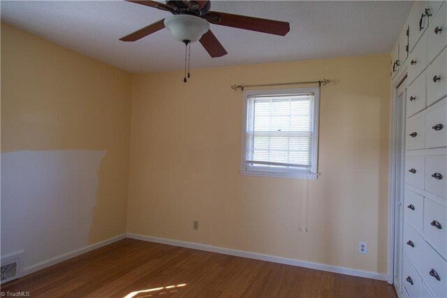 159 Evans Ln, Wilkesboro, NC 28697 - spare room featuring visible vents, ceiling fan, wood finished floors, and baseboards