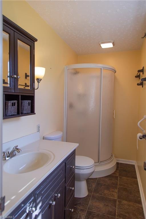 159 Evans Ln, Wilkesboro, NC 28697 - bathroom with vanity, baseboards, a stall shower, a textured ceiling, and toilet