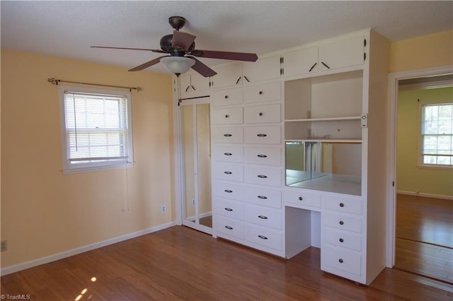159 Evans Ln, Wilkesboro, NC 28697 - unfurnished bedroom featuring dark wood-style flooring, baseboards, and ceiling fan