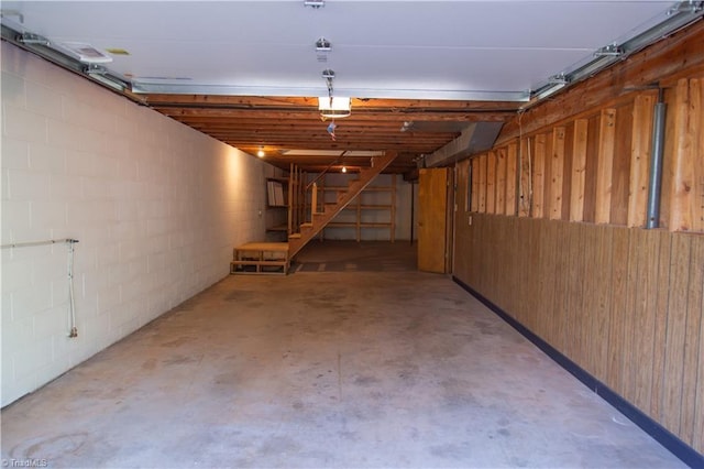 159 Evans Ln, Wilkesboro, NC 28697 - garage featuring a garage door opener, wood walls, and concrete block wall