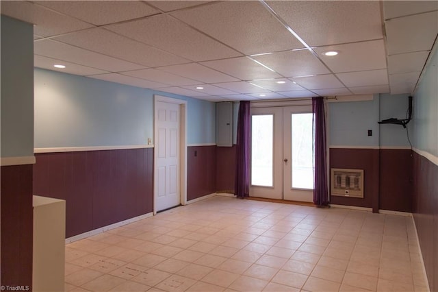 159 Evans Ln, Wilkesboro, NC 28697 - empty room featuring wood walls, wainscoting, a drop ceiling, and french doors