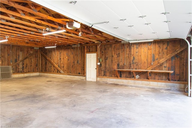 159 Evans Ln, Wilkesboro, NC 28697 - garage with wooden walls and a garage door opener