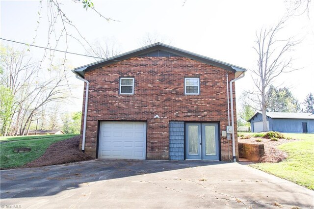 159 Evans Ln, Wilkesboro, NC 28697 - view of home's exterior with brick siding, french doors, a garage, and aphalt driveway