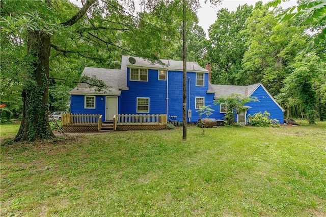 back of house with a lawn and a wooden deck