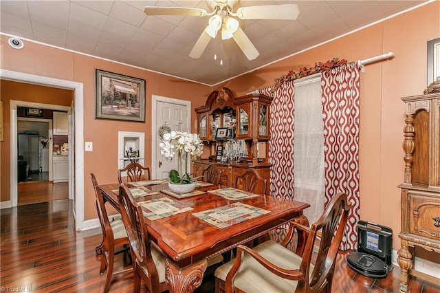 dining area with ceiling fan and dark hardwood / wood-style flooring