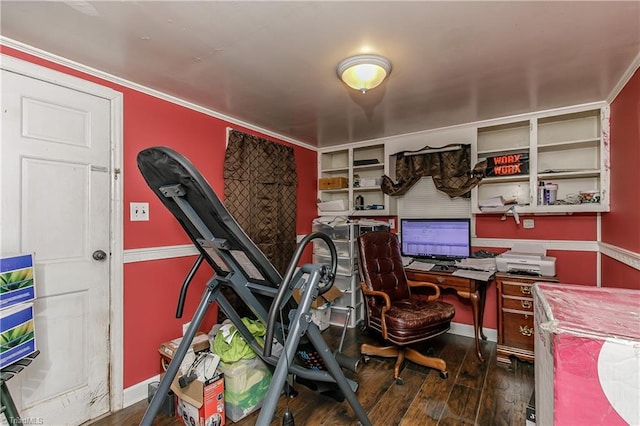 home office with built in shelves, dark hardwood / wood-style floors, and ornamental molding