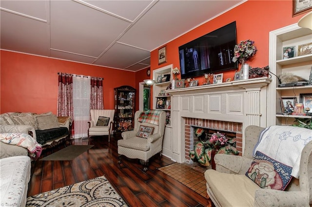 living room with built in shelves, a fireplace, and dark hardwood / wood-style floors