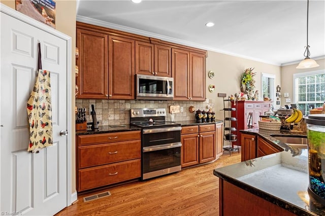 kitchen with decorative backsplash, hanging light fixtures, light hardwood / wood-style flooring, ornamental molding, and stainless steel appliances