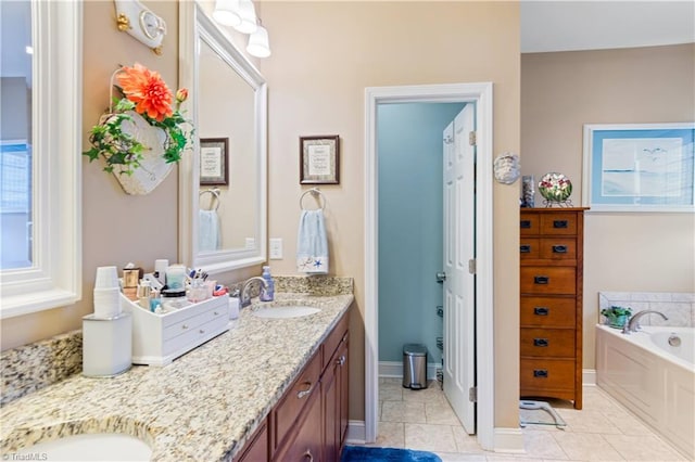 bathroom with vanity, tile patterned flooring, and a bathing tub