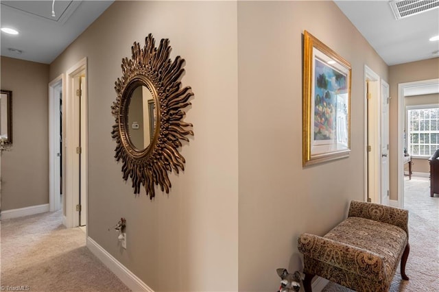 hallway featuring light colored carpet