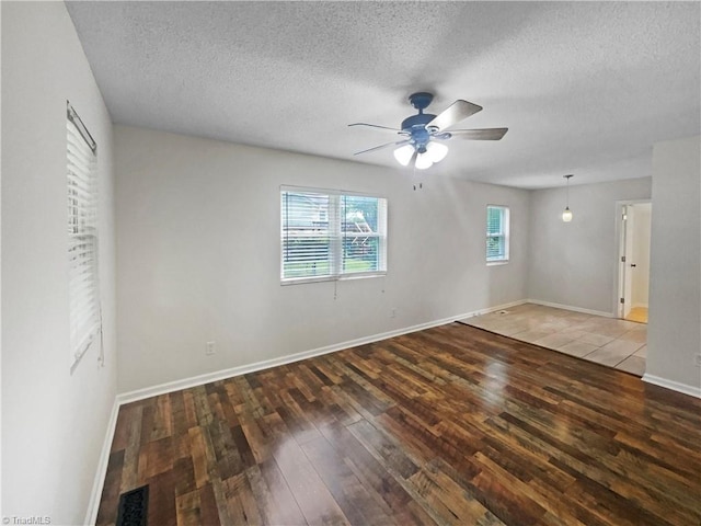 310 Cole St, Thomasville, NC 27360 - unfurnished bedroom featuring wood-type flooring, a textured ceiling, and a ceiling fan