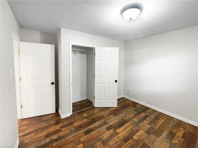 310 Cole St, Thomasville, NC 27360 - unfurnished bedroom featuring dark wood-type flooring, a textured ceiling, and a closet