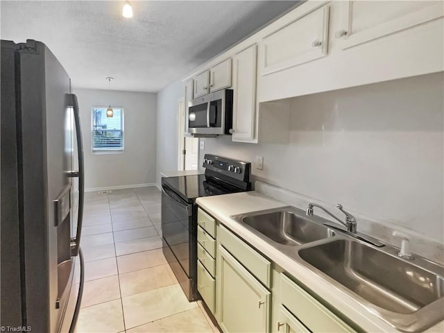 310 Cole St, Thomasville, NC 27360 - kitchen with stainless steel appliances, light countertops, light tile patterned flooring, a textured ceiling, and decorative light fixtures