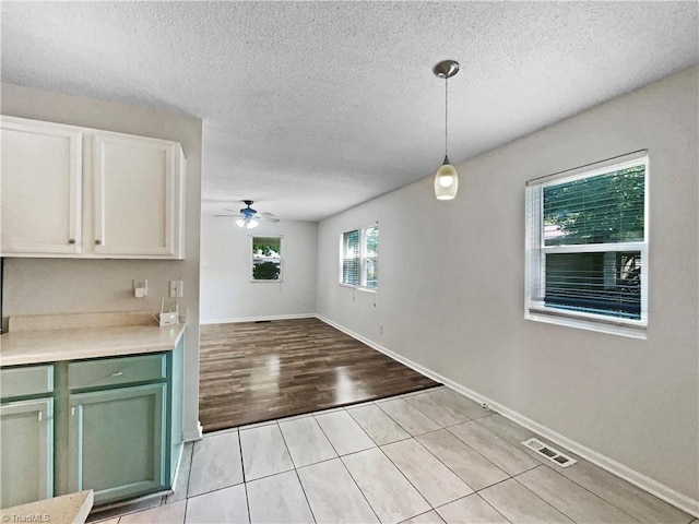 310 Cole St, Thomasville, NC 27360 - unfurnished dining area featuring a ceiling fan, light tile patterned floors, and a textured ceiling