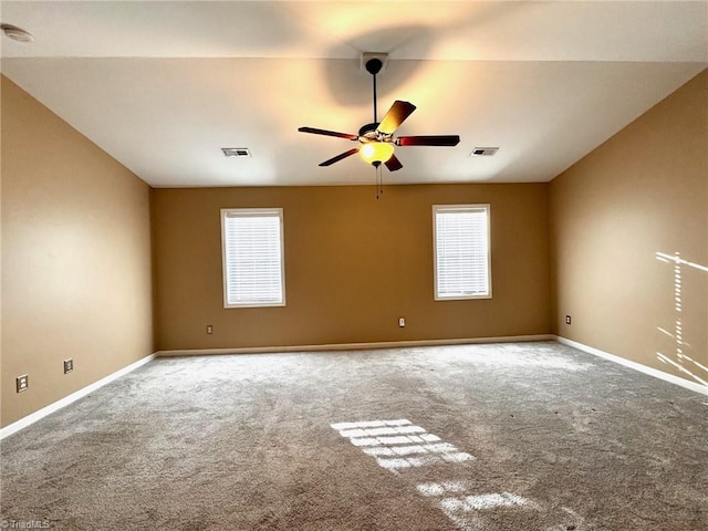 carpeted spare room with a healthy amount of sunlight and ceiling fan