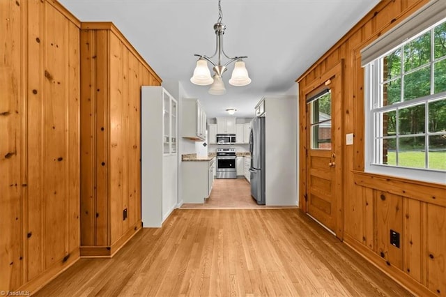 465 NC Highway 42 S, Asheboro, NC 27205 - kitchen with appliances with stainless steel finishes, a chandelier, light wood-type flooring, white cabinets, and pendant lighting