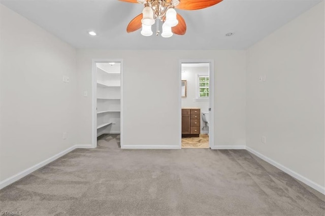 465 NC Highway 42 S, Asheboro, NC 27205 - unfurnished bedroom with a spacious closet, carpet floors, baseboards, connected bathroom, and ceiling fan