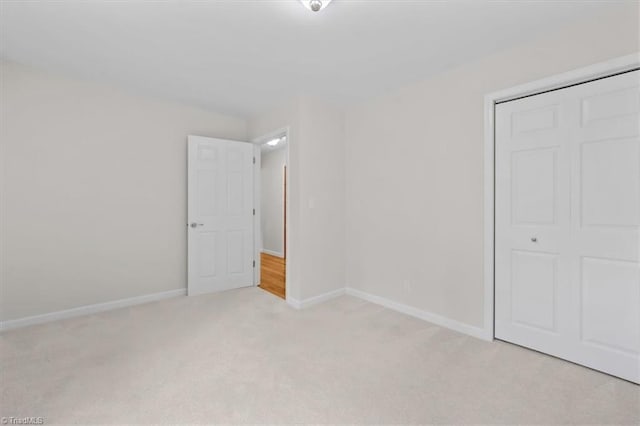 465 NC Highway 42 S, Asheboro, NC 27205 - unfurnished bedroom featuring light carpet, a closet, and baseboards