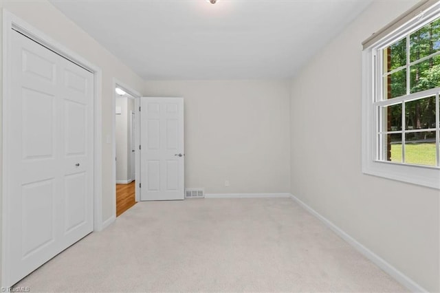 465 NC Highway 42 S, Asheboro, NC 27205 - unfurnished bedroom featuring light colored carpet, multiple windows, and baseboards