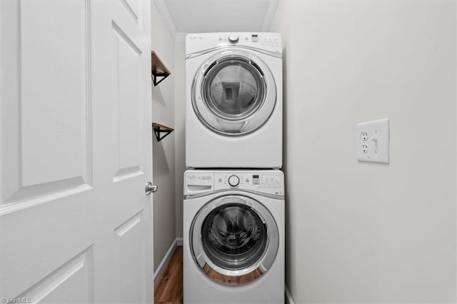 465 NC Highway 42 S, Asheboro, NC 27205 - washroom with stacked washing machine and dryer, ornamental molding, wood finished floors, and baseboards
