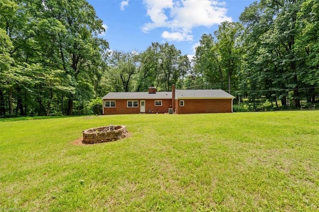 465 NC Highway 42 S, Asheboro, NC 27205 - back of house featuring an outdoor fire pit, a yard, and a chimney