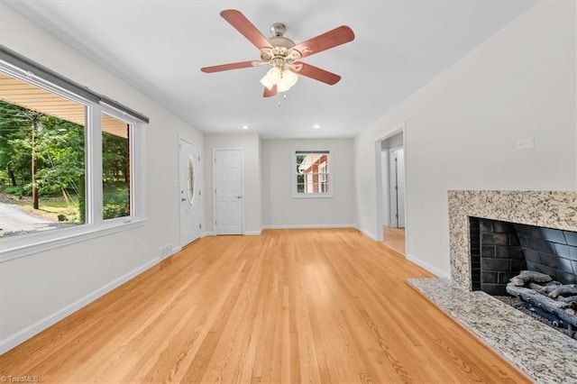 465 NC Highway 42 S, Asheboro, NC 27205 - unfurnished living room featuring light wood-style floors, a premium fireplace, ceiling fan, baseboards, and recessed lighting