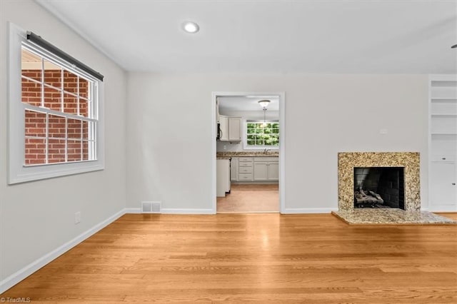 465 NC Highway 42 S, Asheboro, NC 27205 - unfurnished living room with light wood-style floors, a high end fireplace, baseboards, and recessed lighting