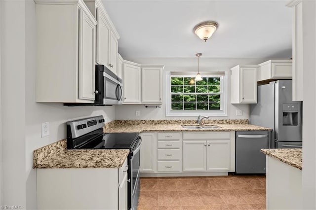 465 NC Highway 42 S, Asheboro, NC 27205 - kitchen featuring stainless steel appliances, a sink, white cabinetry, and light stone counters
