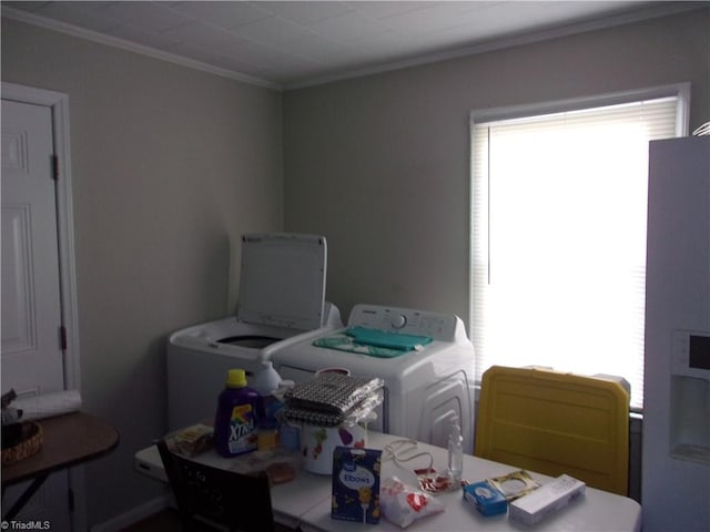 dining space featuring ornamental molding and washer and dryer