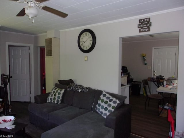 living room featuring crown molding, dark wood-type flooring, and ceiling fan