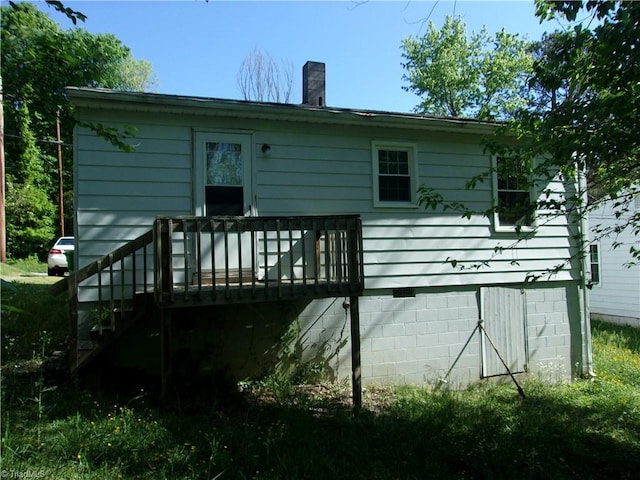 back of property featuring a deck