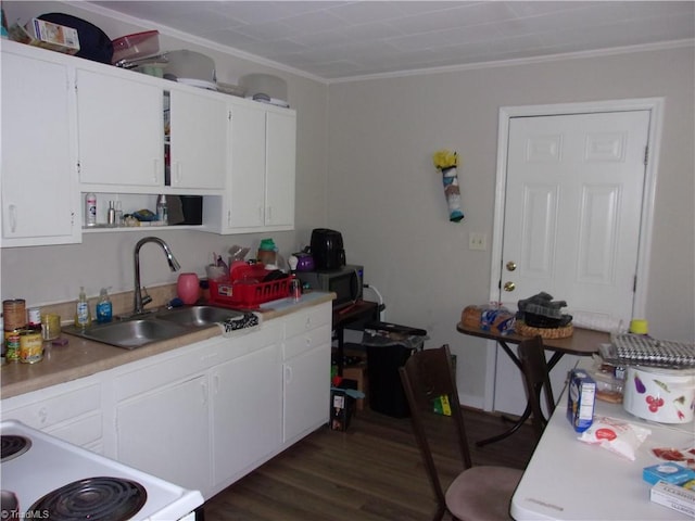 kitchen with white cabinets, sink, dark hardwood / wood-style flooring, and stove