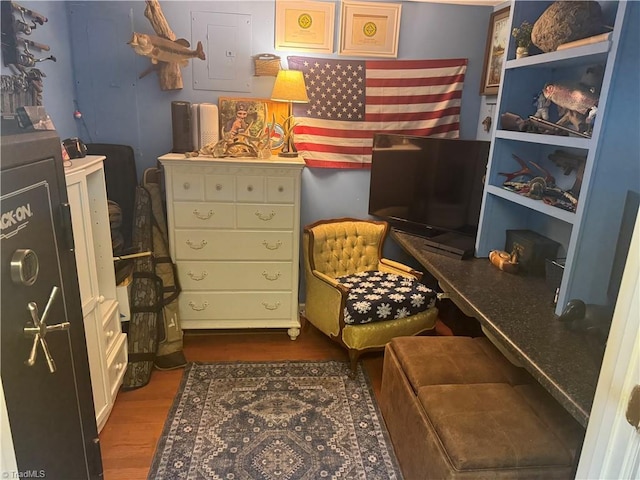 sitting room with dark wood-type flooring and electric panel