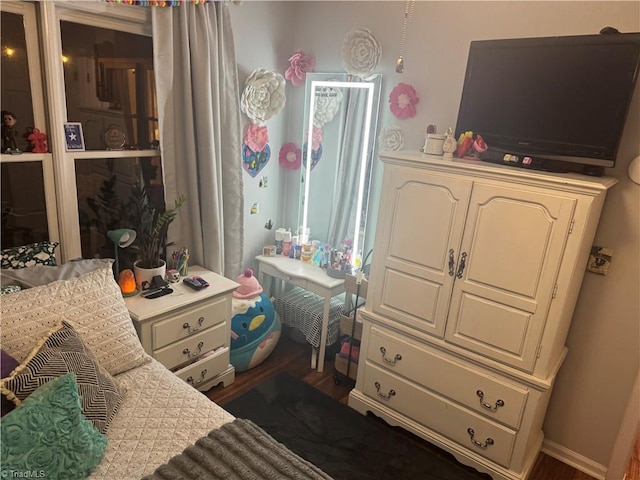 bedroom with dark hardwood / wood-style floors