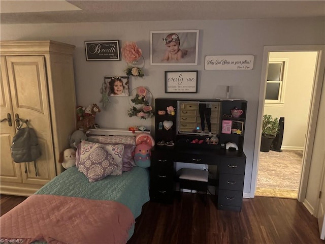 bedroom with dark wood-type flooring