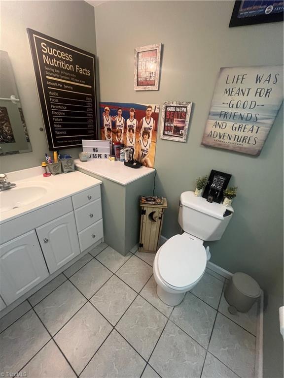 bathroom with vanity, toilet, and tile patterned flooring