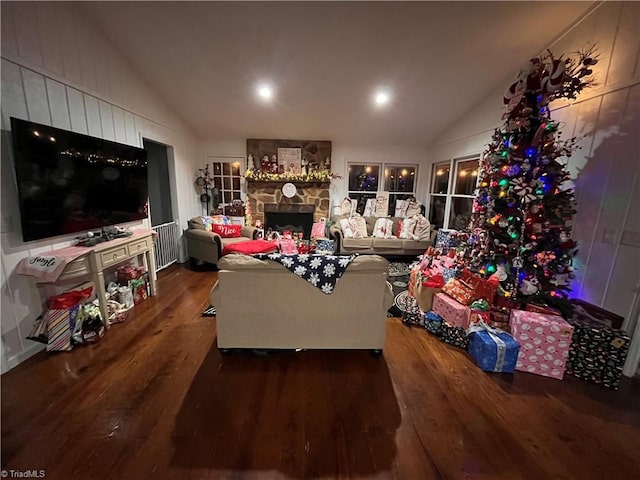 living room with lofted ceiling, a fireplace, and dark hardwood / wood-style flooring