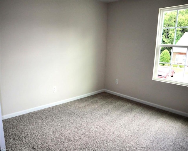 1100 Brooksridge Way, Whitsett, NC 27377 - empty room featuring carpet and baseboards