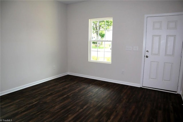 1100 Brooksridge Way, Whitsett, NC 27377 - spare room featuring dark wood-style flooring and baseboards