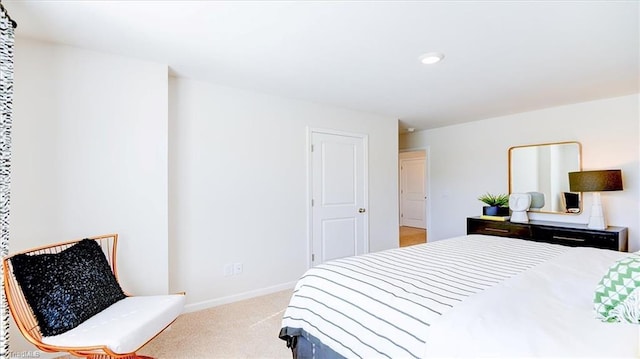bedroom with light carpet and baseboards