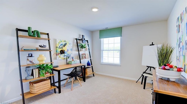 home office featuring baseboards and light colored carpet