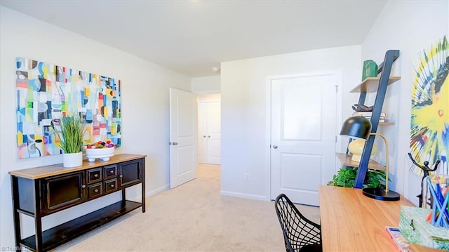 carpeted office featuring baseboards