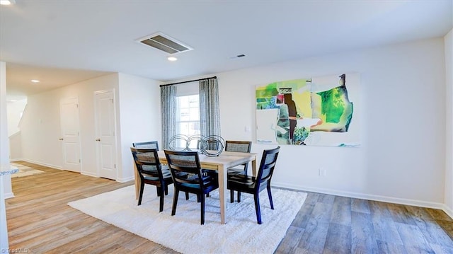 dining room with recessed lighting, visible vents, baseboards, and wood finished floors