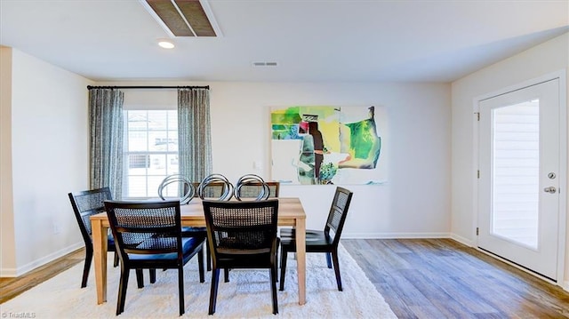 dining room with visible vents, baseboards, and light wood-style flooring