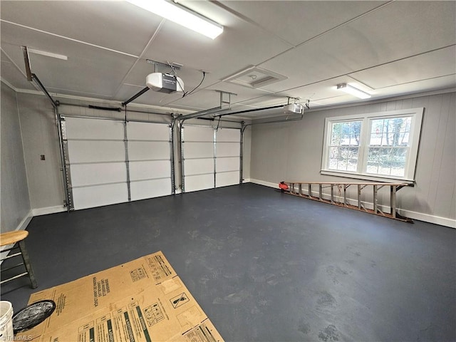 garage with baseboards and a garage door opener