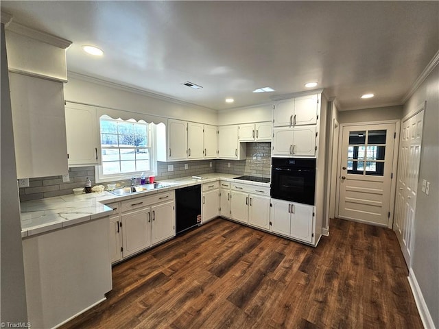 kitchen featuring tile countertops, dark wood-style floors, visible vents, black appliances, and white cabinetry