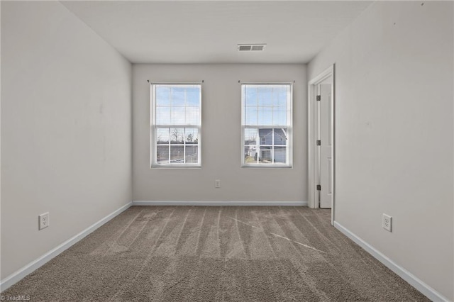 unfurnished room featuring carpet and baseboards